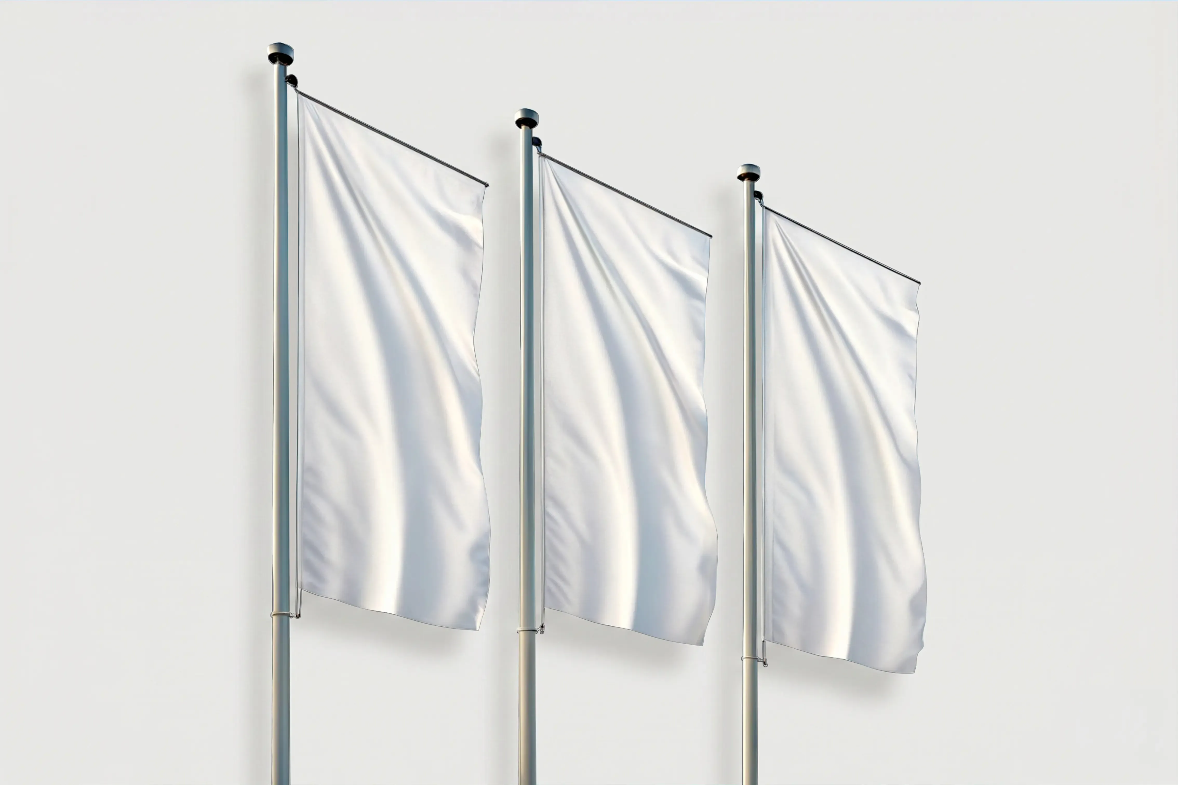 Trzy białe flagi reklamowe bez nadruku zamocowane na aluminiowych masztach. Wizualizacja przedstawia gładkie flagi powiewające na wietrze, przygotowane do personalizacji dowolnym projektem graficznym.