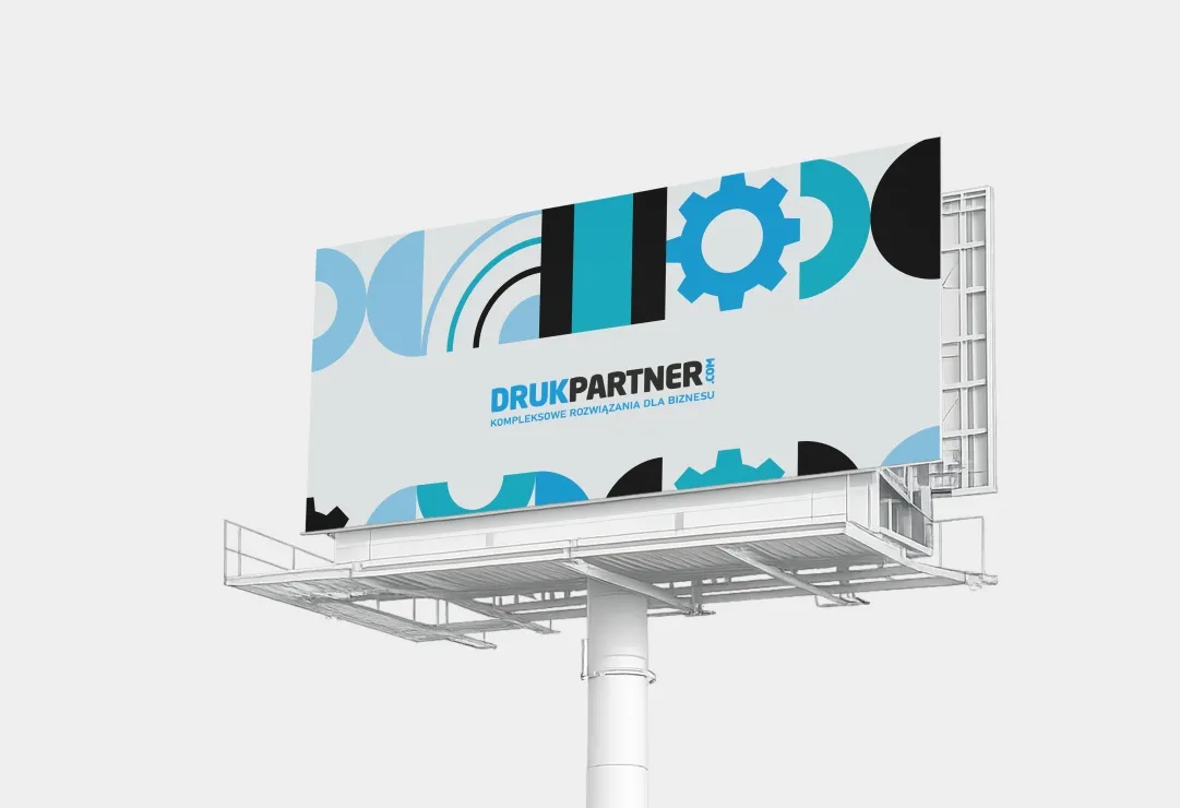 Billboard reklamowy z kolorowym projektem graficznym DrukPartner zamontowany na konstrukcji wolnostojącej, prezentujący przykładową reklamę wielkoformatową.